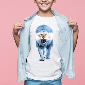 May include: White t-shirt featuring a roaring lion design in the colors of the Argentinian flag: light blue and white. The lion's mane and body are light blue, with the face and details in white. The shirt is worn by a person with a light blue denim shirt.