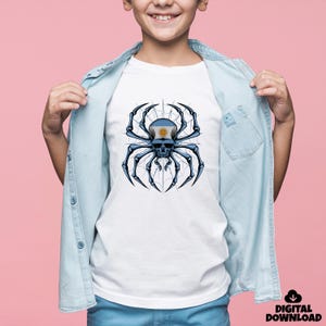 May include: White t-shirt featuring a detailed graphic of a spider skull with the Argentinian flag on its head. The spider is black and blue, set against a web design. The shirt is worn by a person wearing a light blue denim shirt.