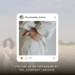 May include: Instagram post featuring a hand in a pocket of cream-colored pants, with a white shirt sleeve visible. The post is framed in a white square with the handle "the_everyday_archive" and social media icons. Text at the bottom reads "FOLLOW US ON INSTAGRAM AT THE_EVERYDAY_ARCHIVE."