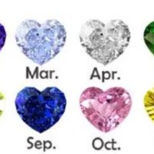 May include: A collection of heart-shaped gemstones in various colors, each representing a month of the year. The months are labeled from January to December, with each gemstone displaying a unique hue, including red, blue, green, and purple.