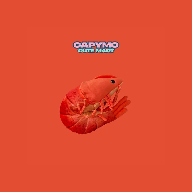 Puede incluir: Un peluche de langosta roja con ojos negros y patas detalladas, sobre un fondo naranja vibrante. El texto "CAPYMO CUTE MART" se muestra encima de la langosta. Este juguete de peluche es para ni&ntilde;os.