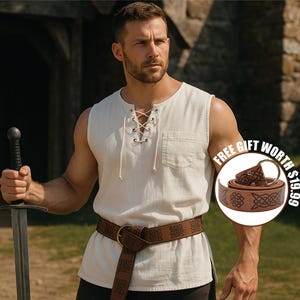 May include: An off-white sleeveless tunic with a lace-up neckline and a brown leather belt with a Celtic knot design. The image also features a sword and a bonus belt.
