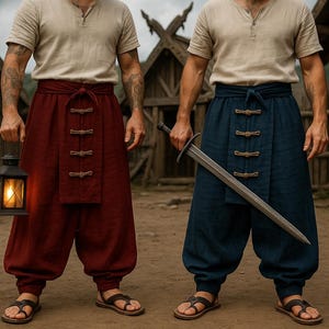 May include: Two people wearing beige shirts, red and blue pants, and sandals. One holds a lit lantern, the other a sword. The pants have decorative closures. The background features wooden structures and a dirt ground.