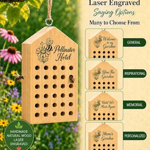 May include: A light-colored wooden pollinator hotel with a house-shaped top, featuring a laser-engraved bee and flower design with the text Pollinator Hotel. It has multiple circular nesting holes and hangs from a jute rope. Includes options for custom sayings.