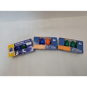 May include: Three boxes of Bethlehem Lights C7 replacement bulbs. Each box contains four bulbs in various colours: blue, orange, and green. The boxes are labelled with the voltage and bulb type.