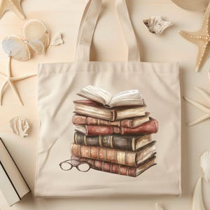 May include: A beige tote bag featuring a watercolor illustration of a stack of books with an open book on top and a pair of glasses. The books are in shades of brown and red. The background includes seashells and starfish.