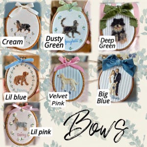 May include: A collection of seven oval embroidery hoops featuring needle-felted portraits of dogs and a cat, each adorned with a decorative fabric bow. The hoops display various fabric backgrounds, including cream, striped, and floral patterns with names.