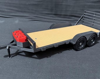 May include: A model of a black and tan trailer with two axles and black tires. The trailer has a wooden deck and a red container on the front. The trailer has a metal frame and a rear gate.