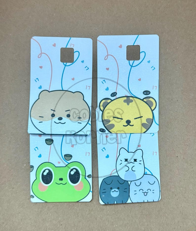 May include: Four rectangular cards with cartoon animal designs. Each card has a light blue background with pink and blue lines and small hearts. The animals include a hamster, tiger, frog, and three cats. Each card has the number "17" printed on it.