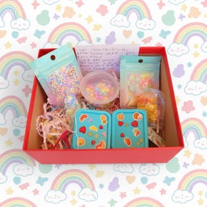 May include: A set of three ceramic mugs with a speckled, matte finish. The mugs are in shades of cream, light brown, and dark brown. Each mug has a simple, minimalist design and a rounded handle. The mugs are stacked on top of each other.