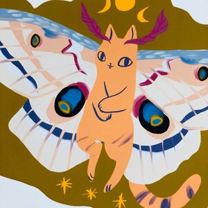 May include: A whimsical illustration of a cat with moth wings. The cat is orange with a pink nose and blue eyes. The moth wings are white, blue, and pink with black accents. The background is a muted brown with a yellow moon and stars.