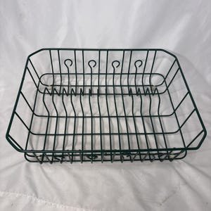 May include: A rectangular dark green wire dish drying rack featuring a grid base for drainage and vertical wire dividers with small loop accents along the top edges. The structure is made of coated metal wire and includes small feet for stability.