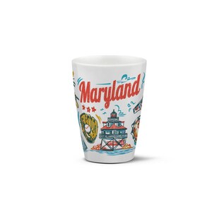 May include: White ceramic tumbler with colorful illustrations of Maryland landmarks and the word "Maryland" in red script. The design includes a baseball glove, lighthouse, and crab.