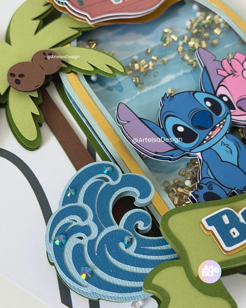 May include: A layered paper craft featuring a blue cartoon character, a pink cartoon character, a palm tree, and a blue wave with sparkling accents. The background includes a beach scene with gold confetti.
