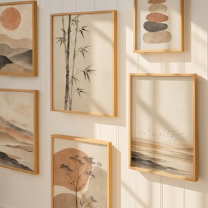 May include: A gallery wall arrangement of six framed prints featuring neutral-toned illustrations of a sun, mountains, bamboo stalks, stacked stones, a plant, and a flock of birds in flight, all enclosed in light wood frames on a white wall.