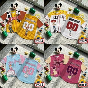 May include: A collection of children's baseball-style shirts featuring characters from the Toy Story franchise. Designs include Woody, Jessie, Bo Peep, and Lotso, with options for personalized names and numbers. Each shirt has a unique color scheme and character graphic.