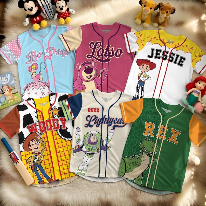 May include: Assortment of baseball jerseys featuring characters from the Toy Story franchise. Jerseys include Bo Peep, Lotso, Jessie, Woody, Buzz Lightyear, and Rex. Each jersey has a unique color scheme and character graphic.