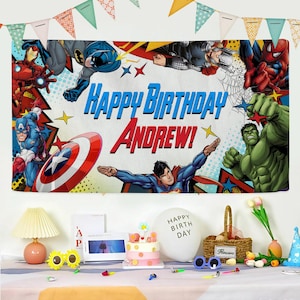 May include: A rectangular birthday banner featuring comic book superheroes including Iron Man, Batman, Thor, Spider-Man, Captain America, Superman, and Hulk. The text reads Happy Birthday Andrew in blue and red lettering against a comic book background.