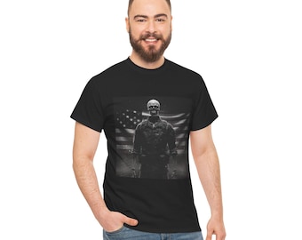 May include: Black t-shirt featuring a grayscale graphic of a skeleton in military attire against an American flag backdrop. The design is centered on the shirt, creating a bold statement. The shirt is made of a soft material.