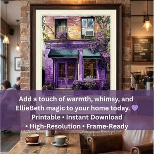 May include: A framed print of a purple storefront with a black awning, surrounded by purple flowers. The image has text that reads "Add a touch of warmth, whimsy, and EllieBeth magic to your home today."