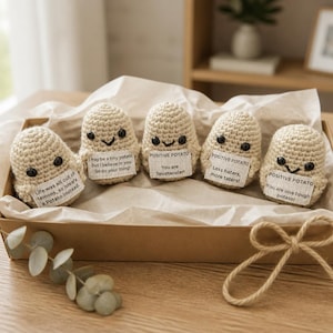 May include: Five crocheted potato figures with smiling faces and small paper signs. The signs read: "Life was all out of lemons, so I reas a Potato instead.", "I may be a tiny potato, but I believe in you. Go do your thing!", "You are Spudtacular!", "Less haters, more taters!", and "You are one tough potato!"