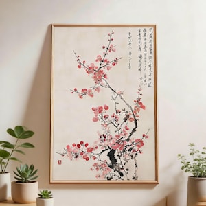 Puede incluir: Una obra de arte enmarcada con una rama de flores de cerezo rosas. La pintura tiene un estilo asiático tradicional, con pinceladas de tinta negra y caligrafía. Las flores son de un rosa vibrante, sobre un fondo color crema.