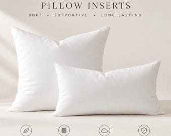 May include: Two white down feather pillow inserts, one square and one rectangular, with text reading DOWN FEATHER PILLOW INSERTS, SOFT, SUPPORTIVE, LONG LASTING, 95% FEATHER 5% DOWN, 100% COTTON DOWN-PROOF COVER, PLUSH & SUPPORTIVE, HYPOALLERGENIC FILL.