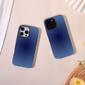May include: Two blue gradient phone cases. The cases have a smooth finish and are designed to fit a smartphone. The cases have cutouts for the camera and other phone features. The cases are a deep blue colour.