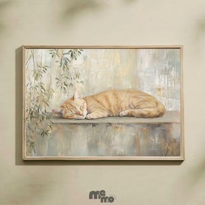 May include: A framed art print depicts a sleeping orange tabby cat. The cat rests on a stone ledge, with a backdrop of muted green and beige tones. The artwork has a soft, painterly style, with leafy vines in the upper left corner.