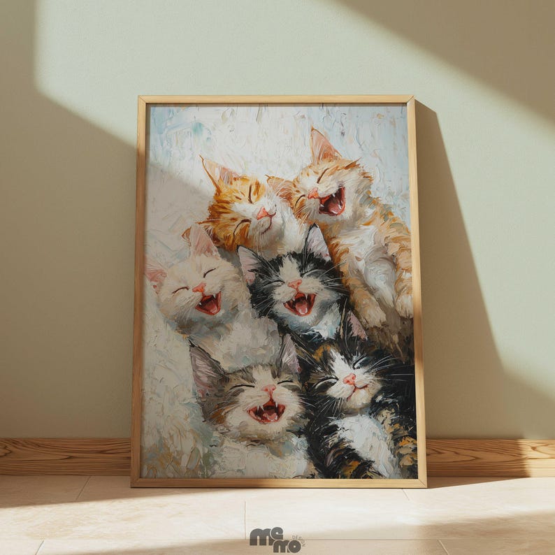 May include: A framed print featuring a group of six smiling kittens. The kittens have various coat colors, including orange, white, black, and gray. The artwork has a painterly style, with visible brushstrokes and soft colors. The frame is made of light-colored wood.