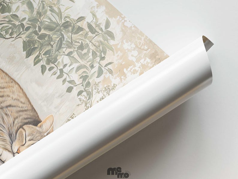 May include: A rolled-up art print featuring a sleeping tabby cat and botanical illustrations in muted tones. The print has a white border and a glossy finish. The cat's fur is a mix of brown, tan, and cream colors.