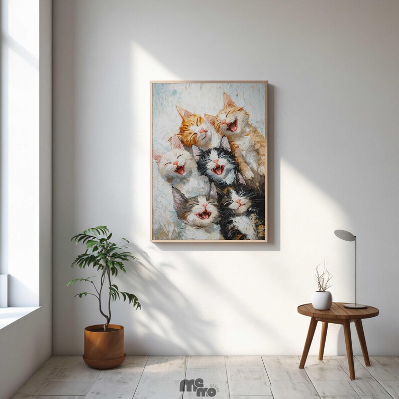 May include: A framed print featuring a group of laughing kittens. The kittens have various fur colors, including orange, white, black, and gray. The artwork has a textured, painterly style, and is displayed in a light-colored wooden frame.