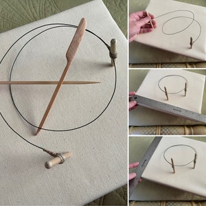 May include: A close-up of a canvas with a black string stretched between two wooden dowels. The string is being used to create a circle on the canvas. There is a wooden dowel with a string attached to it in the lower right corner of the image.