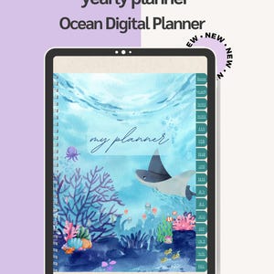 May include: A digital planner with an ocean theme. The cover features an underwater scene with a stingray, coral, and fish. The text "my planner" is written in cursive. The planner is labeled "yearly planner" and "Ocean Digital Planner".