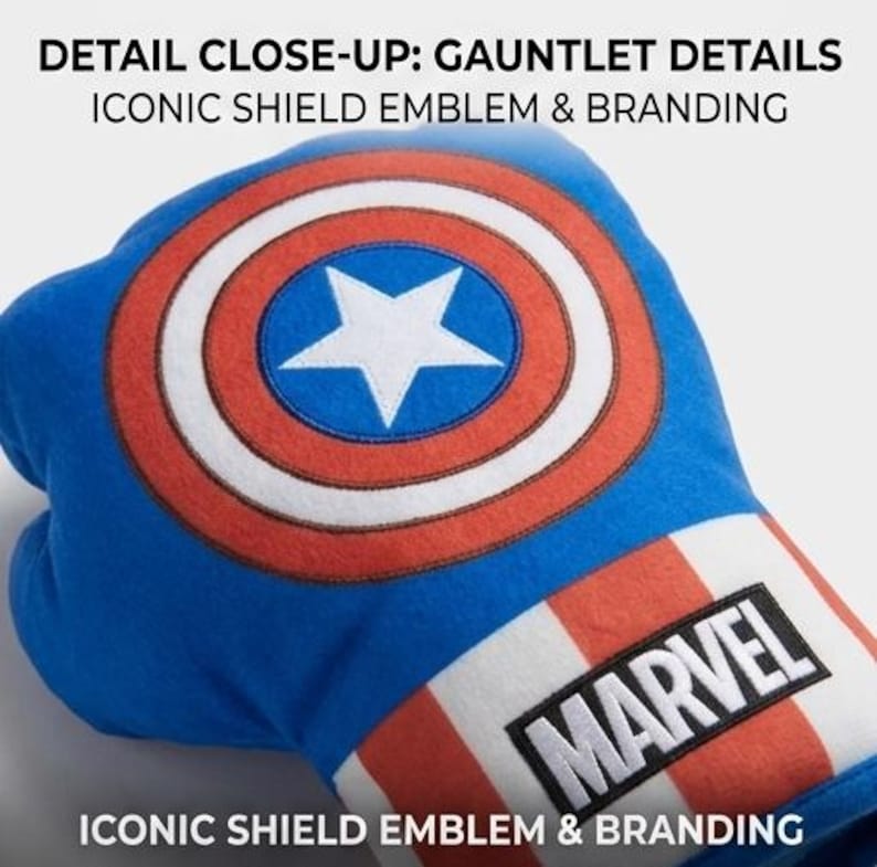 May include: Close-up of a blue gauntlet featuring the iconic shield emblem with a white star and red and white stripes. The gauntlet has the word "MARVEL" in a black rectangle.
