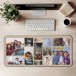 May include: A beige rectangular desk mat featuring a collage of family photos, pets, and nature scenes. The mat is placed on a light wood desk, with a keyboard, computer monitor, and a cup of coffee visible.