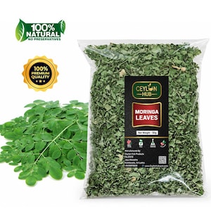May include: A clear plastic bag filled with dried green moringa leaves, labeled Ceylon Hub Moringa Leaves with a net weight of 50g. Beside the bag are fresh green moringa leaves. The image includes a 100% natural and 100% premium quality seal.