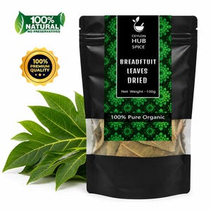 May include: A black pouch of dried breadfruit leaves with a green floral design and the text "CEYLON HUB SPICE BREADFTUIT LEAVES DRIED". The pouch is labeled "100% Pure Organic" and "Net Weight - 100g". Fresh green breadfruit leaves are to the left.