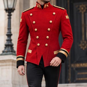May include: A vibrant red double-breasted jacket featuring a high collar, gold-toned buttons, and black cuffs with gold trim. The jacket includes gold shoulder epaulets and is paired with black trousers that have a thin red side stripe and black boots.