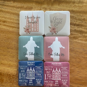 May include: Six square magnets with religious themes. The magnets feature images of a temple, a shield, and a silhouette of a person with the words "Come Follow Me". The magnets also include text about baptism, faith, and the Holy Ghost.