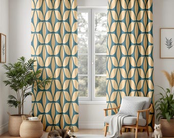 May include: Teal and beige patterned curtains hanging in front of a window. The curtains have a repeating geometric design. A cat is lying on a white rug in front of the curtains. A chair, plants, and a framed picture are also in the room.