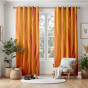 May include: A pair of orange and red patterned curtains with eyelet tops hang in a living room with a chair and a potted plant.