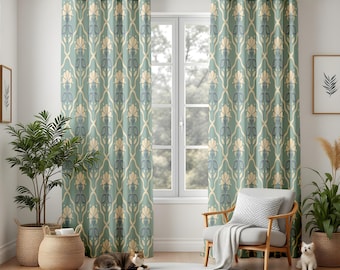 May include: Two matching teal curtains with a repeating floral pattern in cream and light blue hang in front of a window. The curtains are in a room with a wooden floor, a white rug, and a wooden chair.