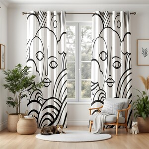 May include: A pair of floor-length curtains featuring a bold black and white line art pattern of abstract faces and curved shapes. The curtains are hung on a dark metal rod with silver grommets, displaying a continuous graphic design.