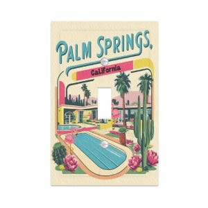 May include: A light switch cover featuring a retro illustration of Palm Springs, California. The design includes a swimming pool, palm trees, and a flamingo, with the words "Palm Springs" and "California" in a vintage font.