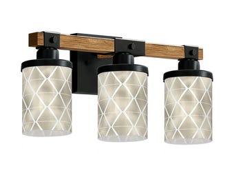 May include: A three-light vanity fixture with a wood-look beam and black metal accents. The cylindrical shades feature a geometric diamond pattern. The fixture is designed for wall mounting and provides ambient lighting.