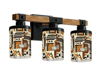 May include: A three-light vanity fixture with a wood-tone beam and black metal accents. The cylindrical shades feature a retro geometric pattern in shades of brown, beige, and gray. The fixture is designed for wall mounting.