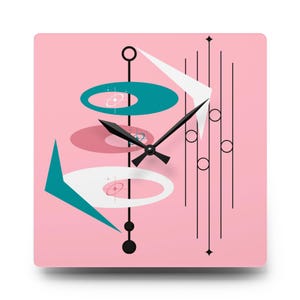 May include: A square wall clock with a pink background and a mid-century modern design. The clock features teal, white, and pink geometric shapes, black lines, and black clock hands. The clock's design is reminiscent of the atomic age.