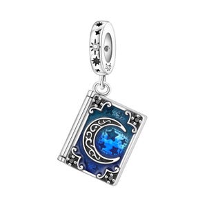 May include: A silver charm with a book design. The book has a blue cover with a crescent moon and stars. The charm's top has a star and a small gem. The charm is made of S925 silver.