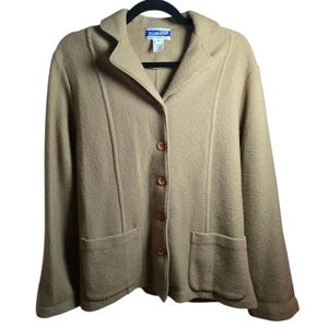 May include: A tan wool blazer with a notched collar, two front pockets, and wooden buttons. The blazer has a tailored fit and is hanging on a black hanger. The brand name "Pendleton" is visible on the label.